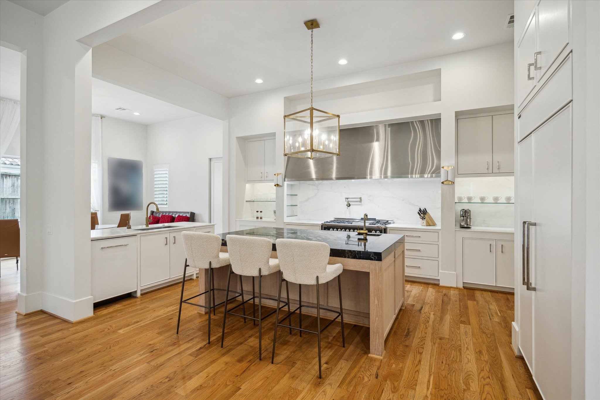 22 East Shady Lane, Unit E Houston, TX 77063 - Photo 14 of 50 a kitchen with a dining table chairs and white cabinets