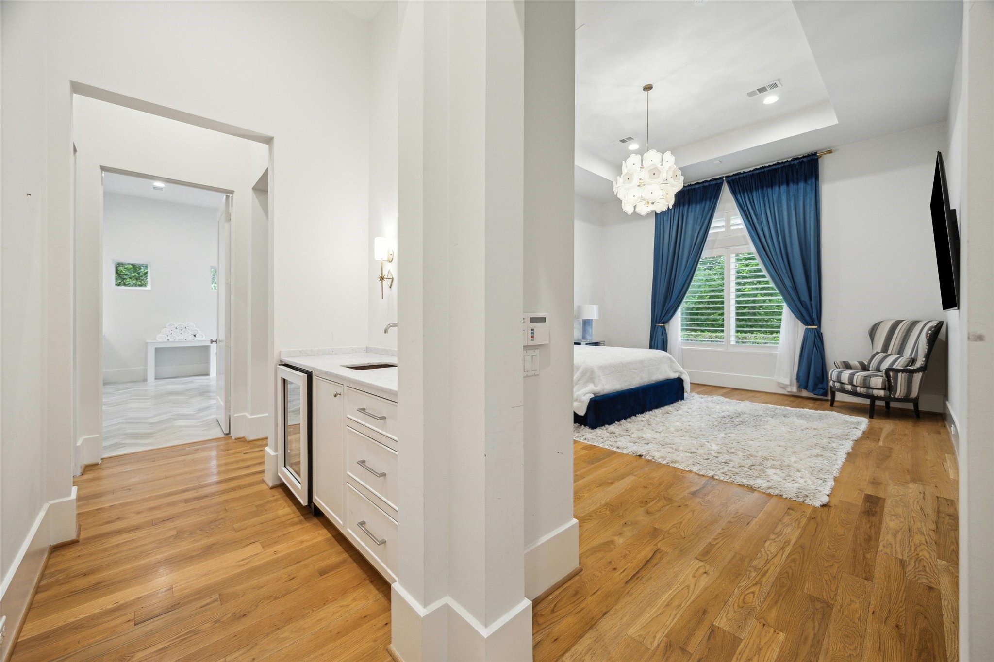 22 East Shady Lane, Unit E Houston, TX 77063 - Photo 21 of 50 a bedroom with furniture and a wooden floor