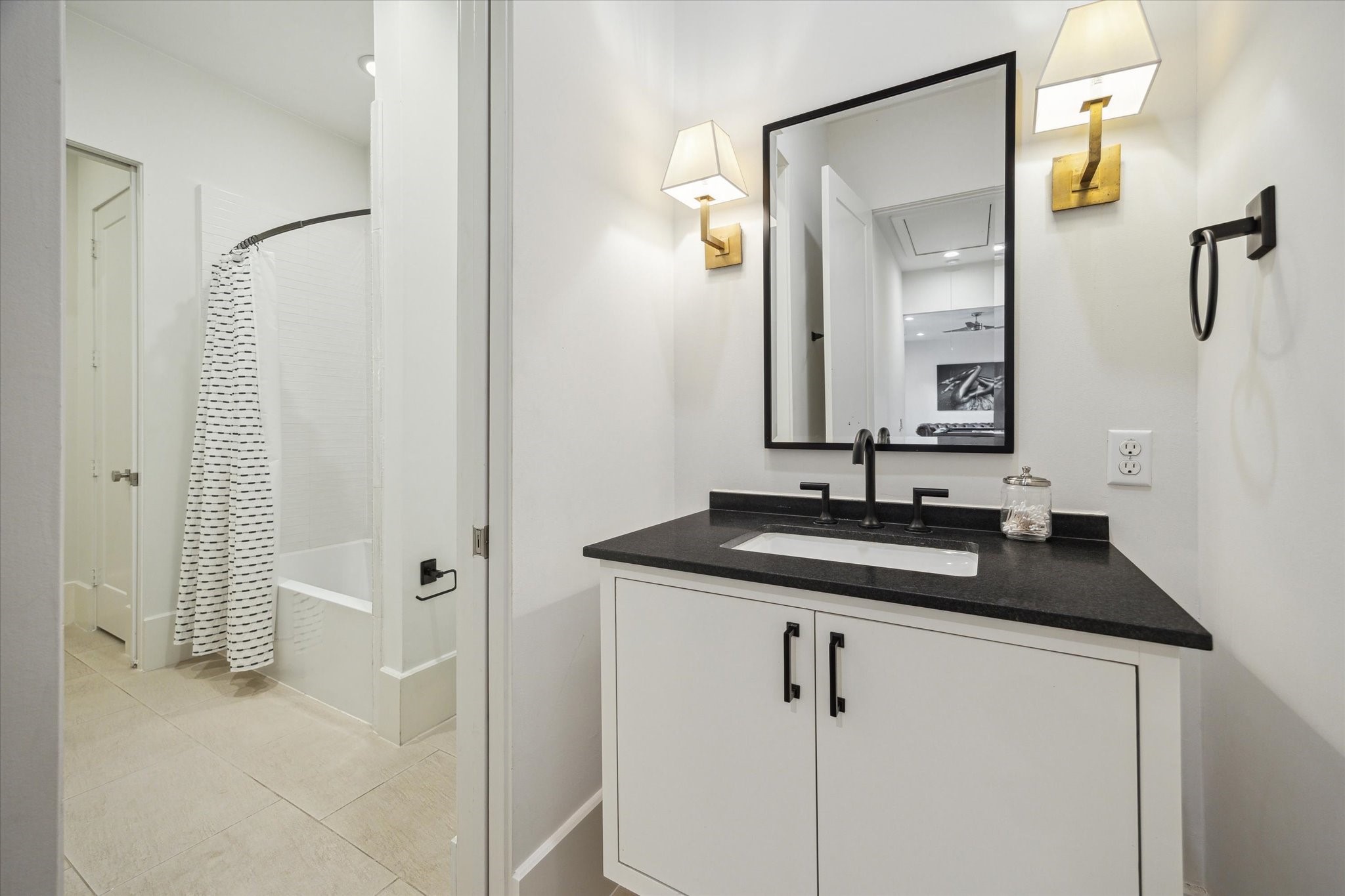 22 East Shady Lane, Unit E Houston, TX 77063 - Photo 34 of 50 a bathroom with a granite countertop sink and a mirror