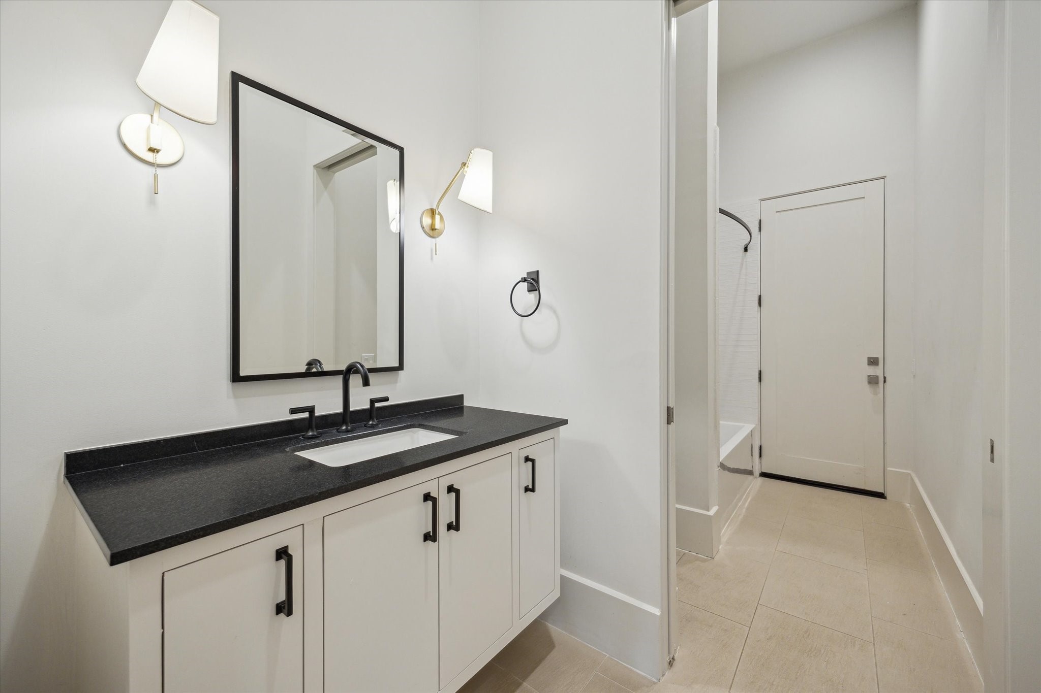 22 East Shady Lane, Unit E Houston, TX 77063 - Photo 38 of 50 a bathroom with a sink and a mirror