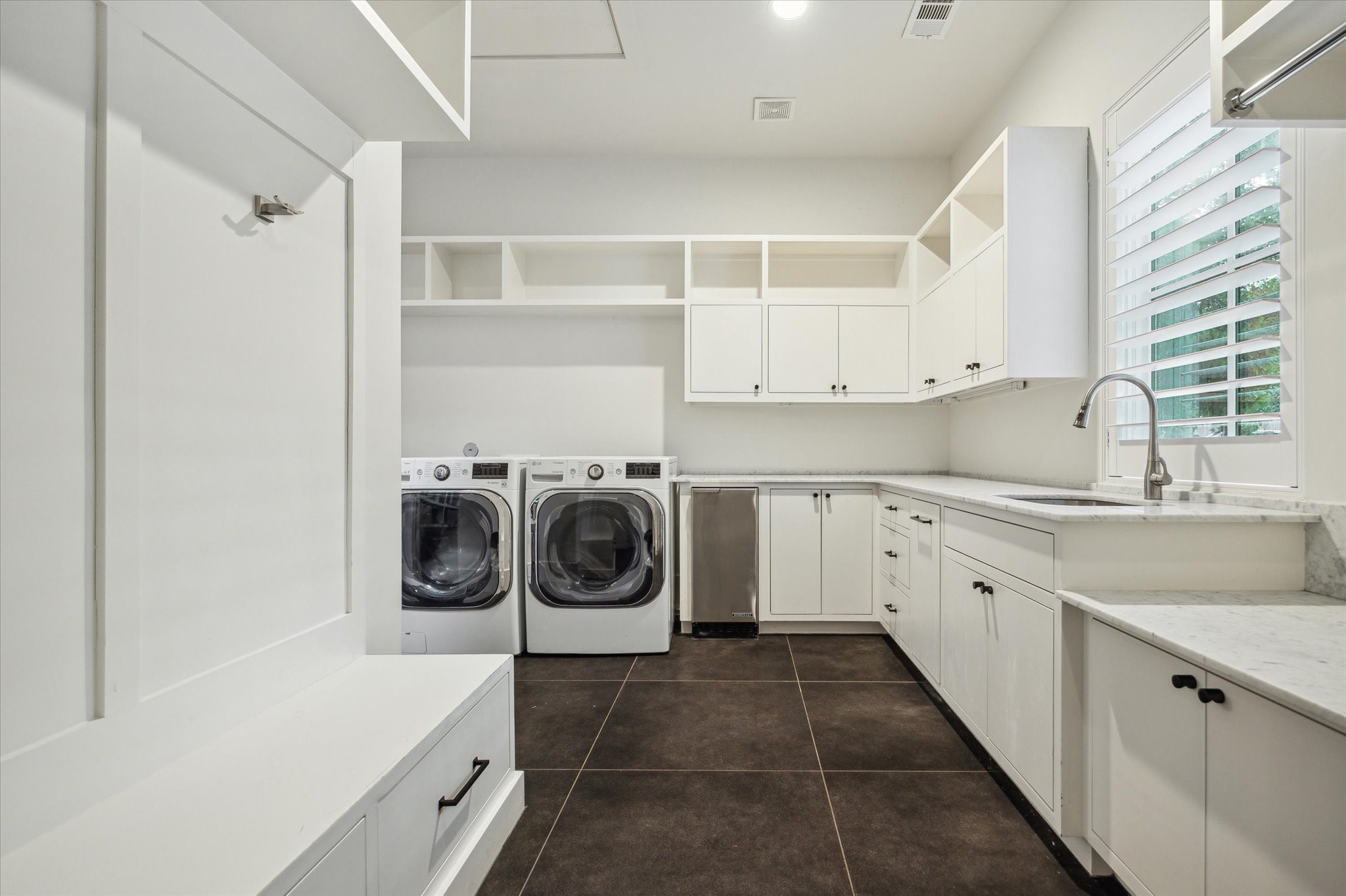 22 East Shady Lane, Unit E Houston, TX 77063 - Photo 39 of 50 a utility room with cabinets washer and dryer