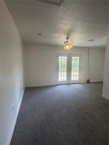 an empty room with a window and fireplace