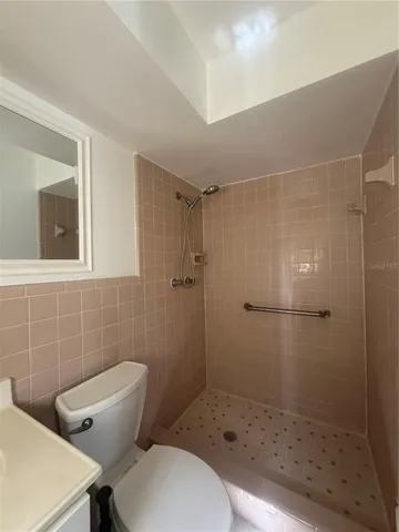 a bathroom with a toilet and a shower