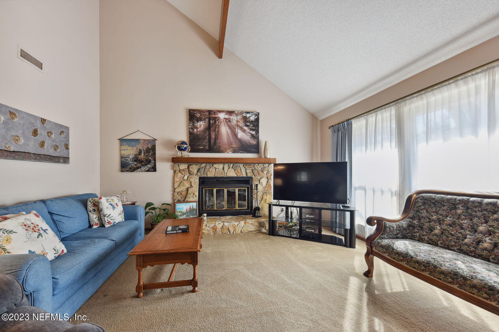 5327 Bedford Road Jacksonville, FL 32207 - Photo 3 of 16 a living room with furniture and a flat screen tv