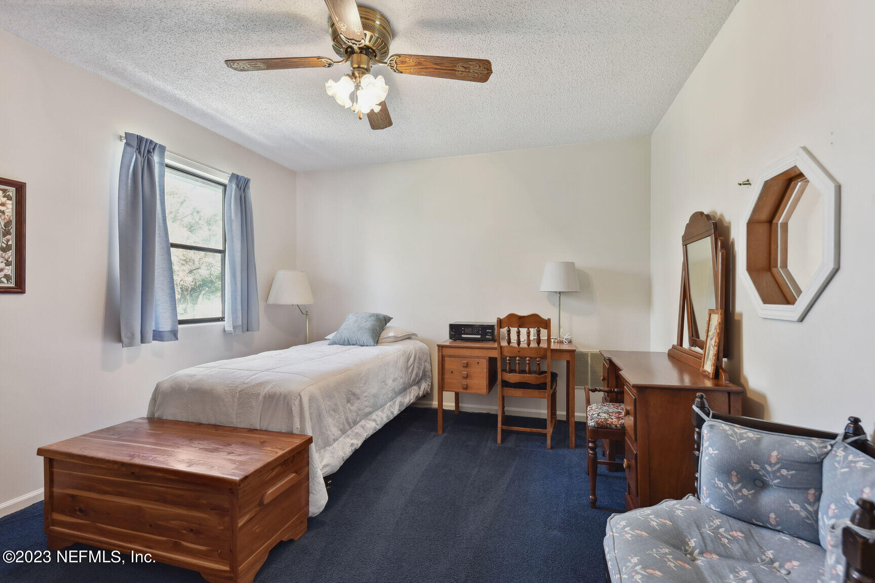 5327 Bedford Road Jacksonville, FL 32207 - Photo 9 of 16 a bedroom with furniture and a window