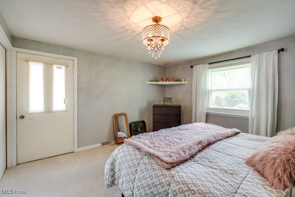 5867 Wiclif Road Northeast Canton, OH 44721 - Photo 19 of 45 Bedroom with a chandelier, carpet flooring, and baseboards