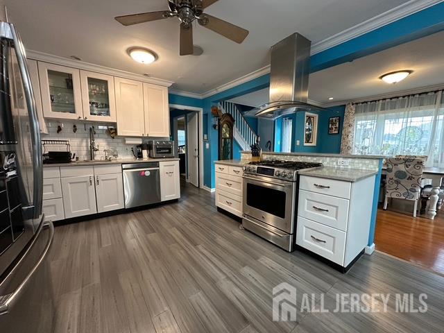 78 Schoder Avenue Woodbridge, NJ 07095 - Photo 11 of 26 a kitchen with stainless steel appliances granite countertop wooden floors and sink
