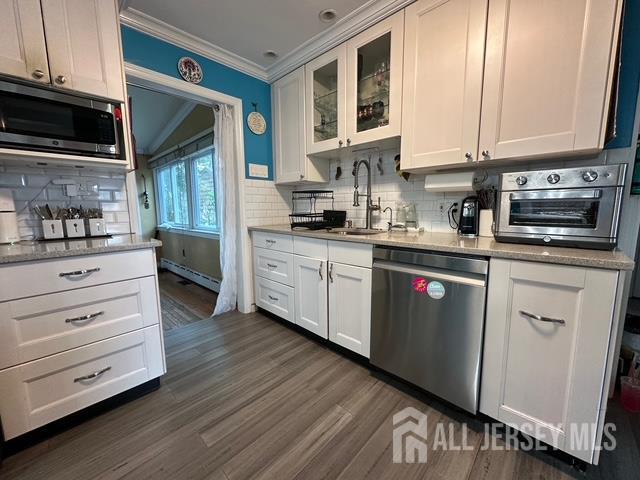 78 Schoder Avenue Woodbridge, NJ 07095 - Photo 13 of 26 a kitchen with stainless steel appliances granite countertop a stove sink and cabinets