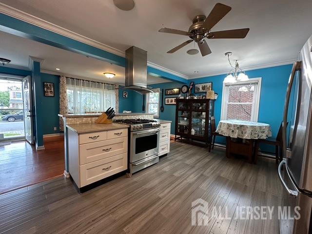78 Schoder Avenue Woodbridge, NJ 07095 - Photo 15 of 26 a kitchen with stainless steel appliances kitchen island wooden floors stove and white cabinets