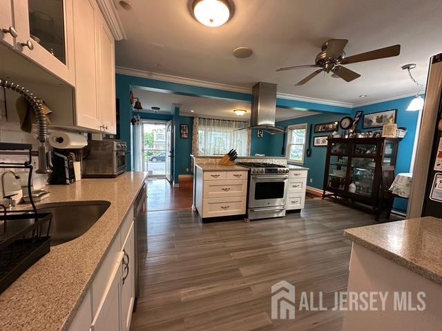78 Schoder Avenue Woodbridge, NJ 07095 - Photo 16 of 26 a kitchen with stainless steel appliances granite countertop a lot of counter space and wooden floor