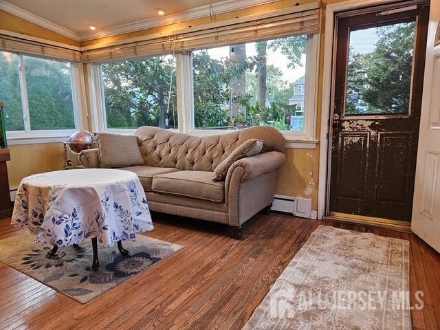 78 Schoder Avenue Woodbridge, NJ 07095 - Photo 17 of 26 a living room with furniture large windows and wooden floor