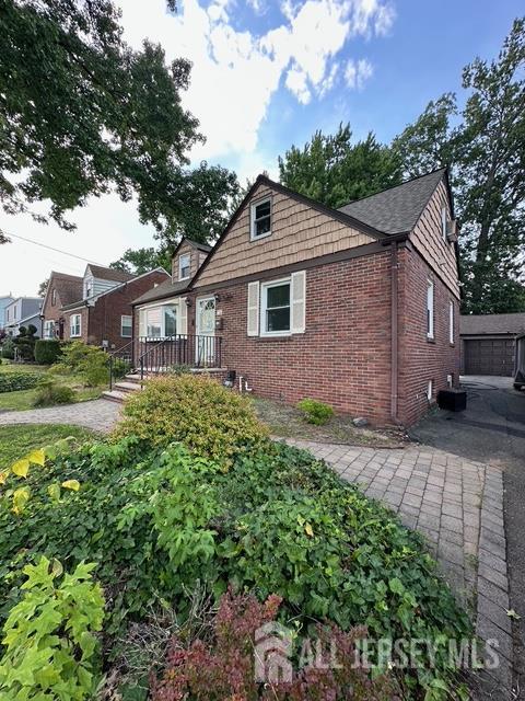 78 Schoder Avenue Woodbridge, NJ 07095 - Photo 3 of 26 a front view of a house with a garden