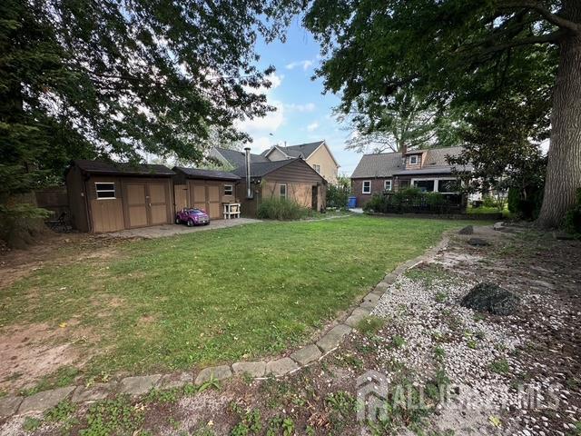 78 Schoder Avenue Woodbridge, NJ 07095 - Photo 4 of 26 a front view of a house with a garden and trees