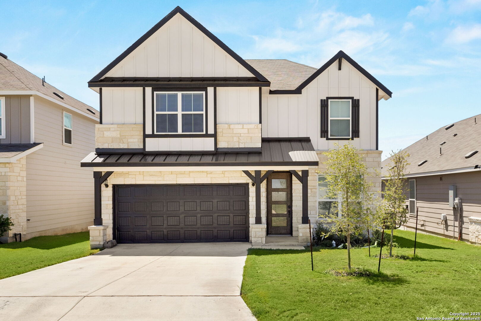 a front view of a house with a garden and yard