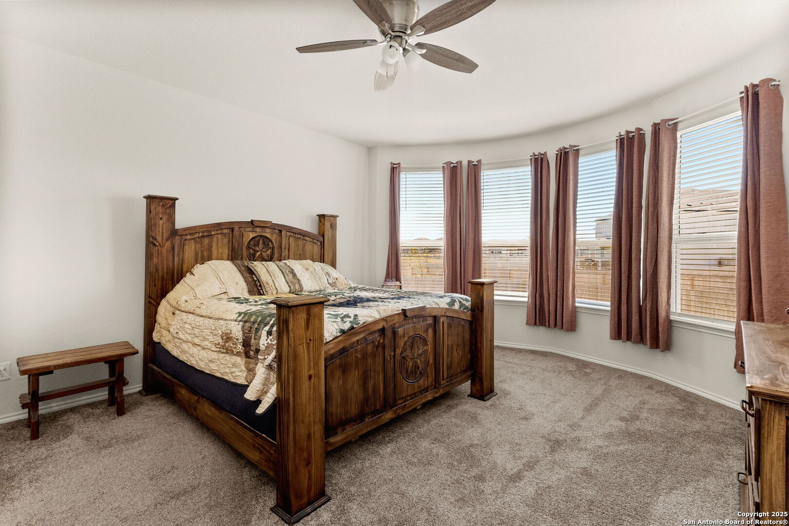 4012 Wild Bloom Road Seguin, TX 78155 - Photo 12 of 26 a bed sitting in a spacious bedroom next to a window