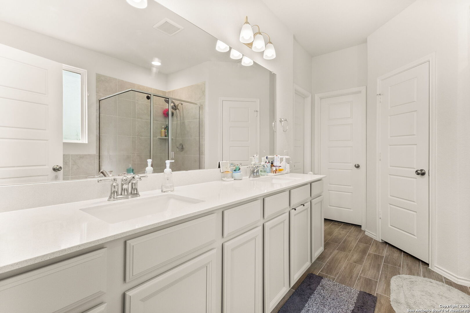 4012 Wild Bloom Road Seguin, TX 78155 - Photo 13 of 26 a bathroom with a double vanity sink mirror and