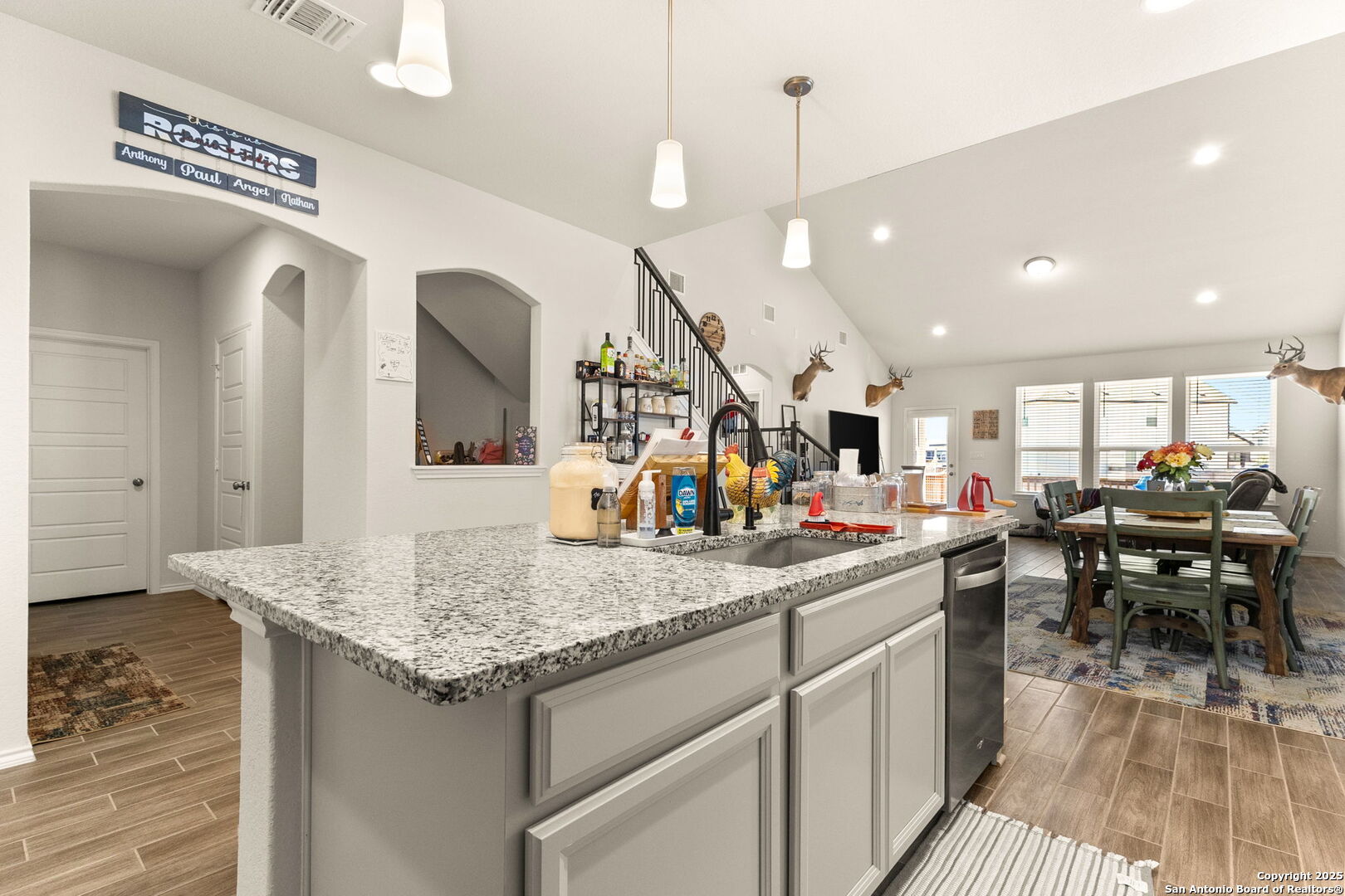 4012 Wild Bloom Road Seguin, TX 78155 - Photo 6 of 26 a kitchen with stainless steel appliances granite countertop counter space a sink cabinets and wooden floor