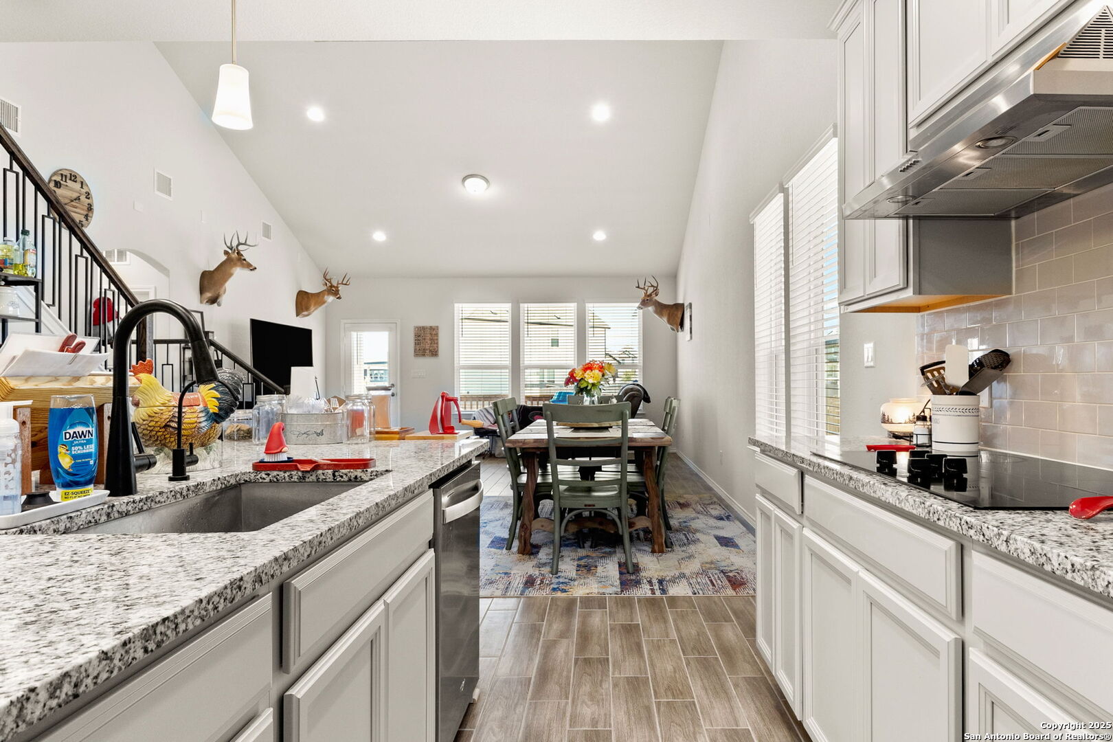 4012 Wild Bloom Road Seguin, TX 78155 - Photo 7 of 26 a kitchen view with white cabinets and chairs
