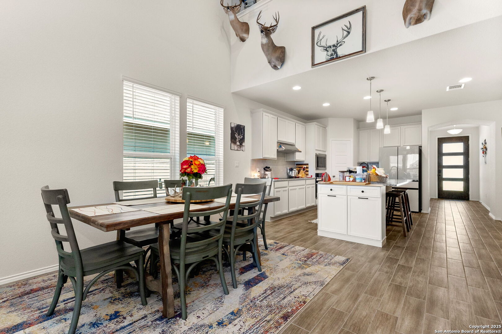 4012 Wild Bloom Road Seguin, TX 78155 - Photo 8 of 26 a view of a dining room with furniture and wooden floor