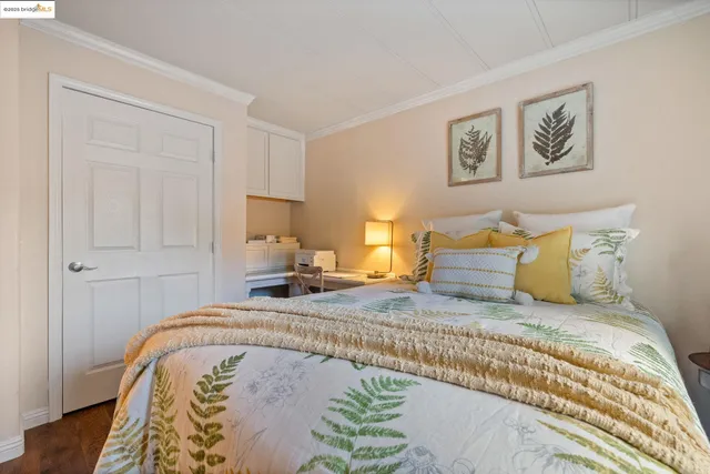 a bedroom with a bed and a large window