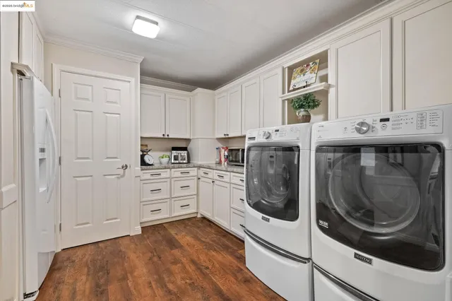 a kitchen with white cabinets and white appliances