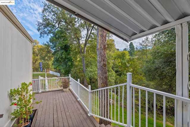 a view of a balcony with wooden floor and stairs