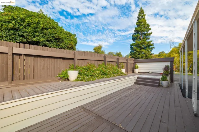 a view of a porch with furniture and a yard