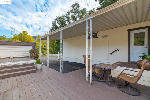 a view of a balcony with wooden floor