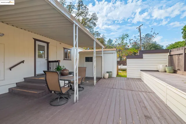 a view of a patio with table and chairs and wooden floor