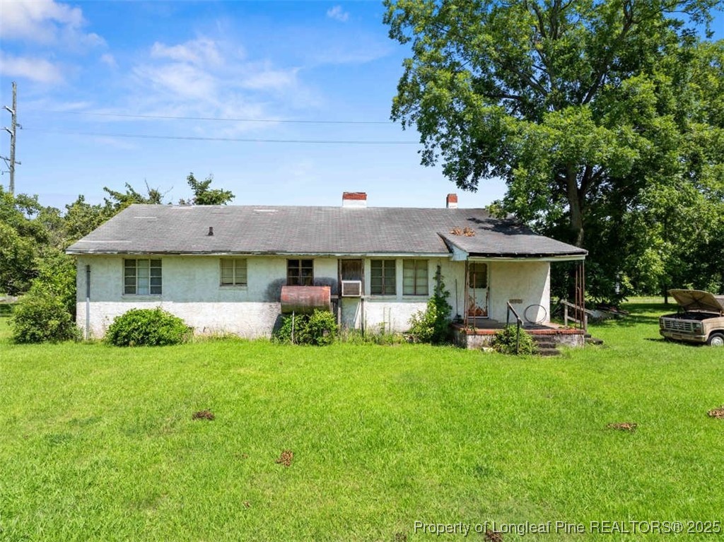 4247 River Road Wade, NC 28395 - Photo 9 of 17 a front view of a house with garden and trees