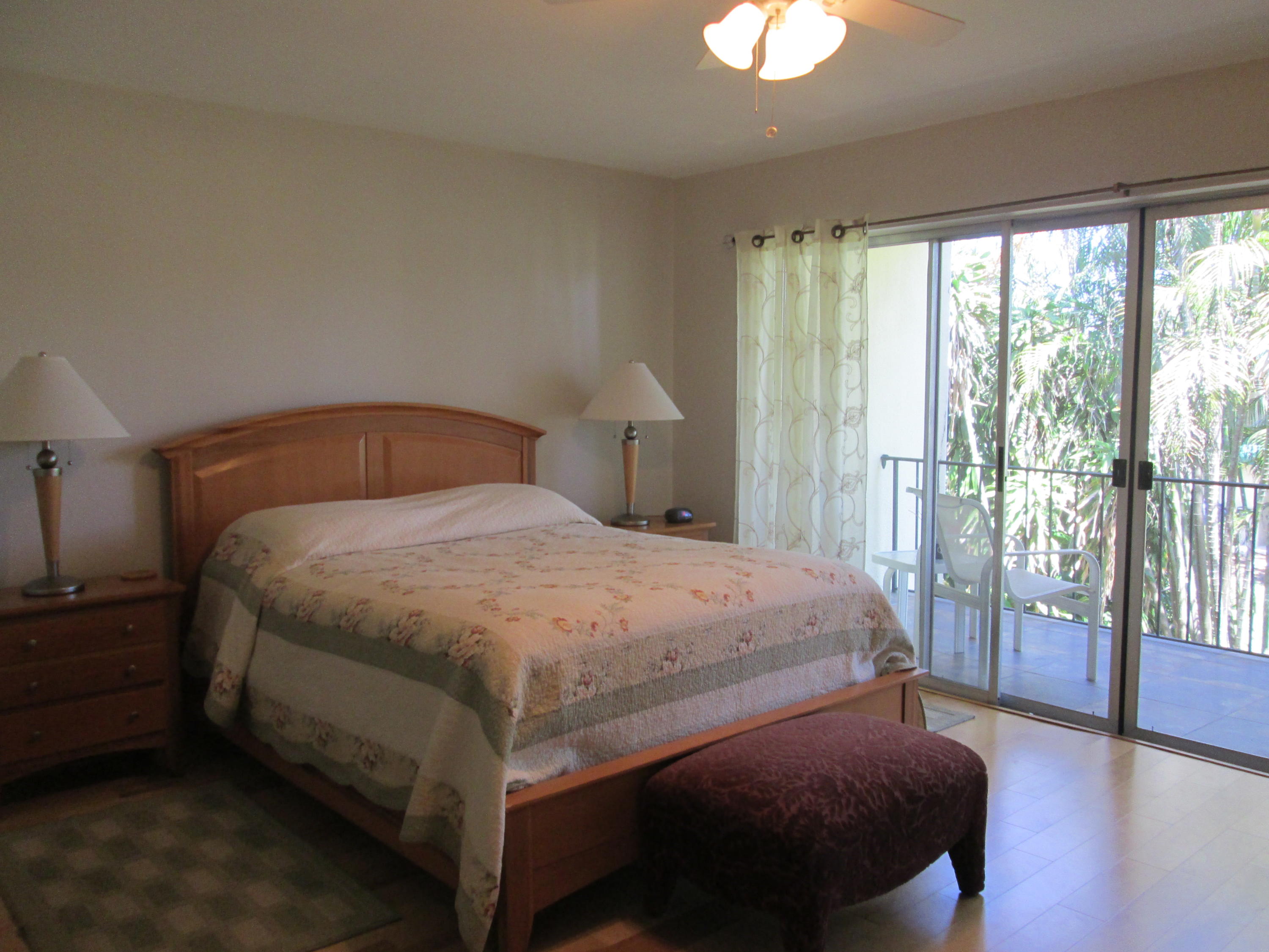388 Golfview Road, Unit C North Palm Beach, FL 33408 - Photo 11 of 16 a bedroom with a bed and a lamp next to a window