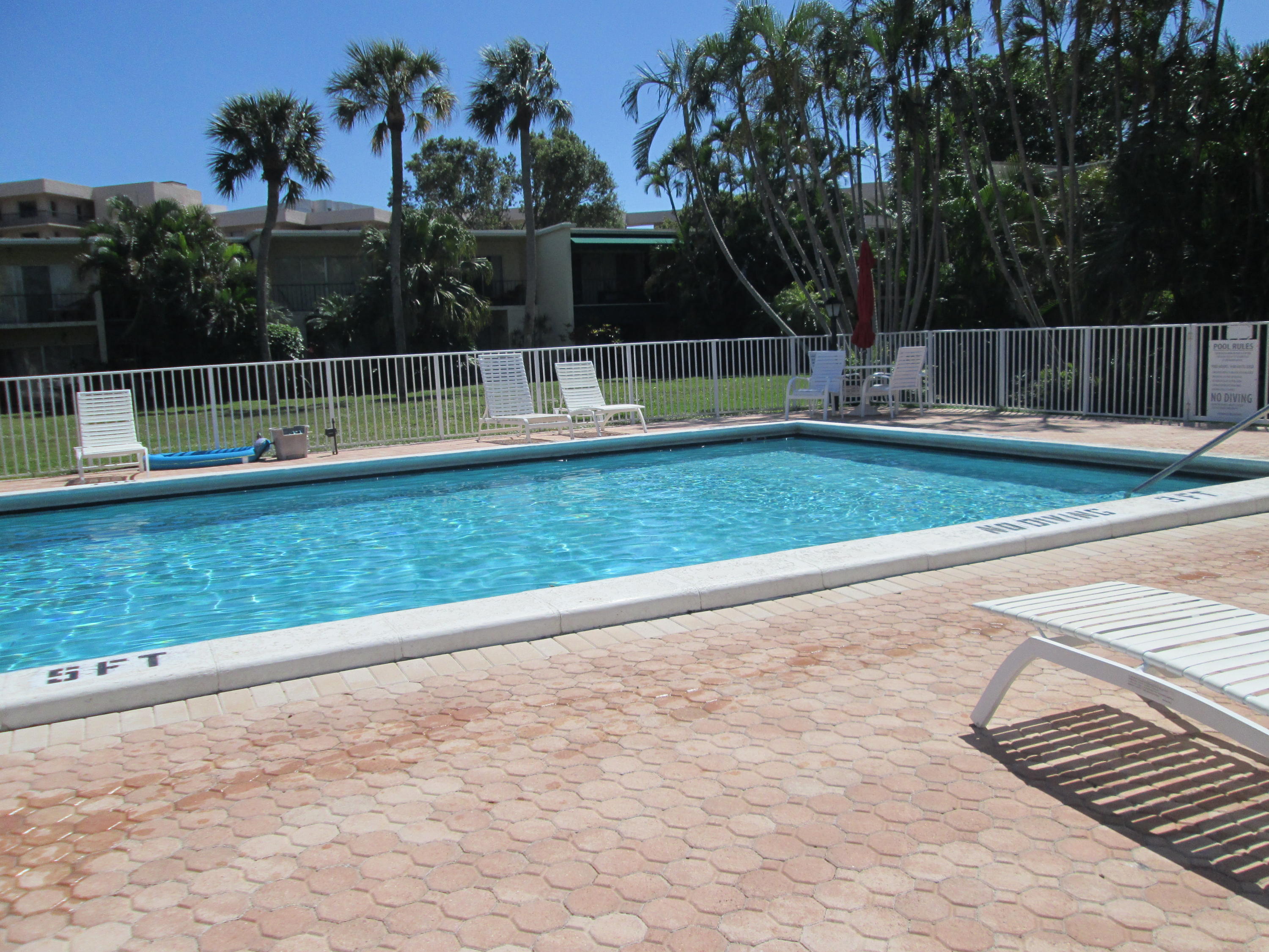 388 Golfview Road, Unit C North Palm Beach, FL 33408 - Photo 16 of 16 a view of a yard and basketball court