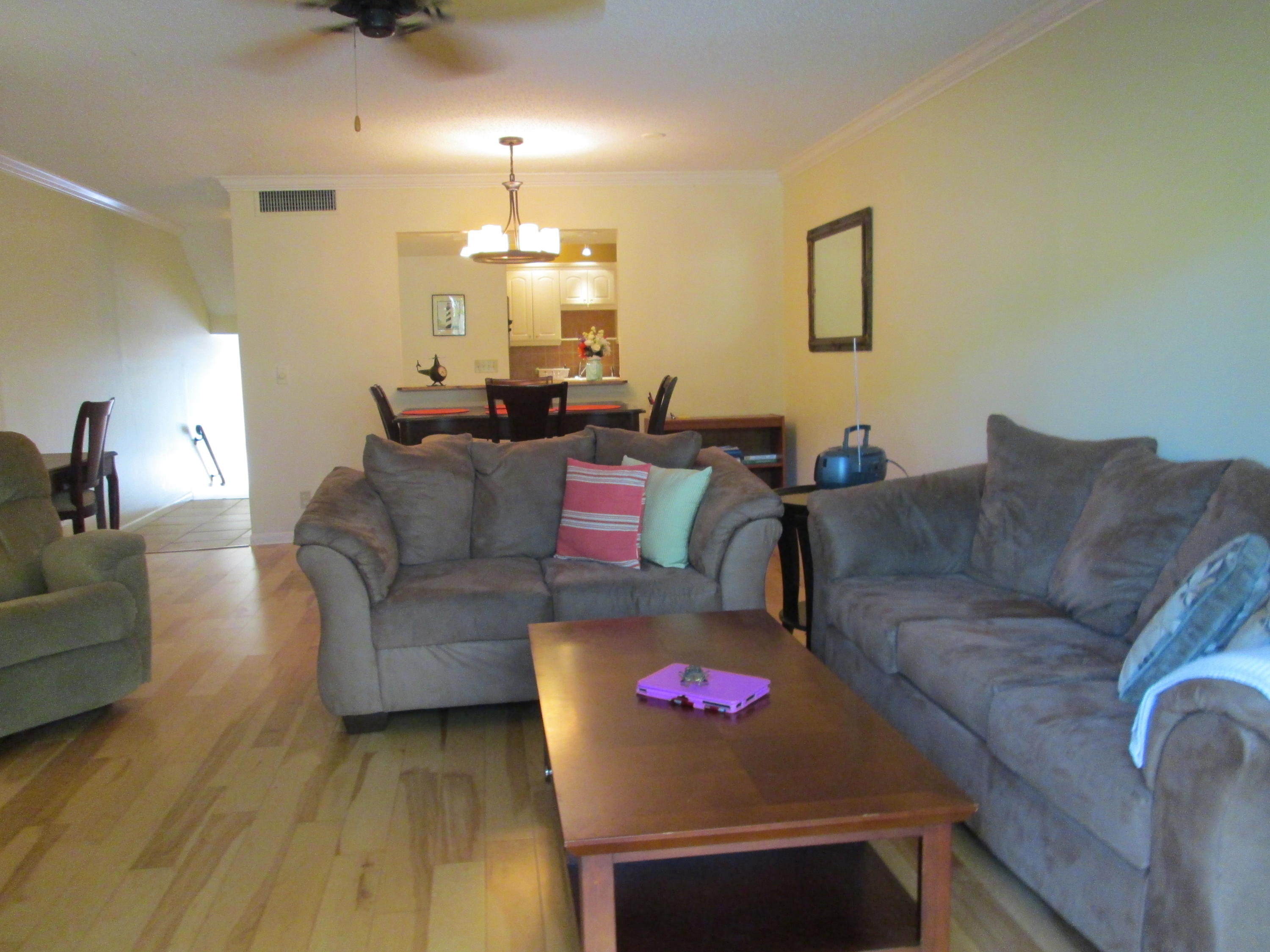 388 Golfview Road, Unit C North Palm Beach, FL 33408 - Photo 3 of 16 a living room with furniture and a wooden floor