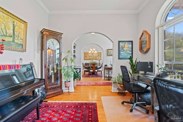 a living room with furniture a rug and a floor to ceiling window