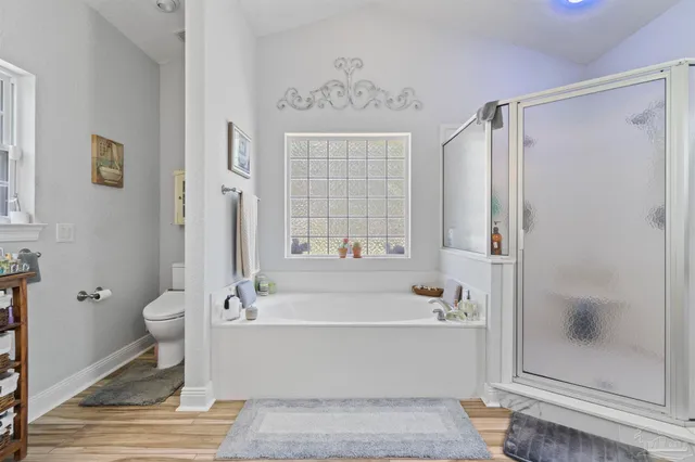 a bathroom with a bathtub a toilet and a shower