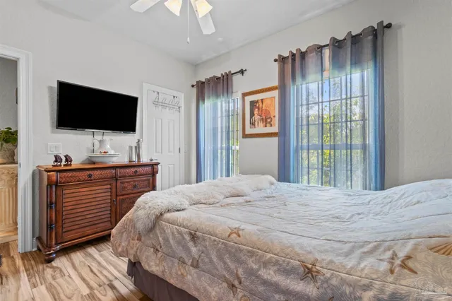 a bedroom with a bed and a flat screen tv