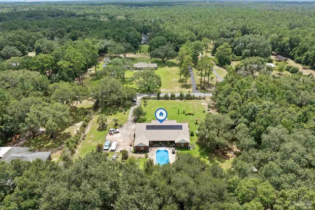 an aerial view of a house with a yard