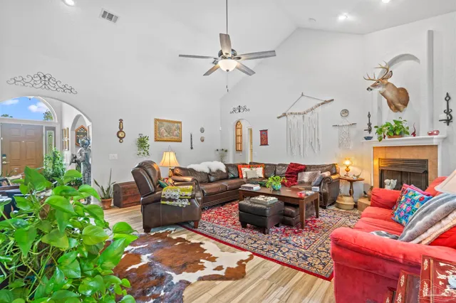 a living room with furniture a fireplace and a chandelier