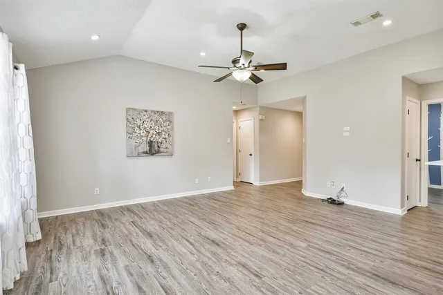wooden floor in an empty room with a window