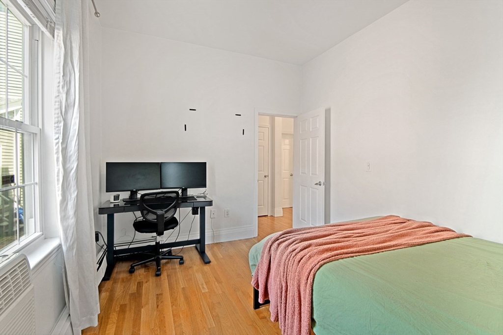 249 Roxbury Street, Unit 1 Boston, MA 02119 - Photo 11 of 19 a bedroom with a bed and a window