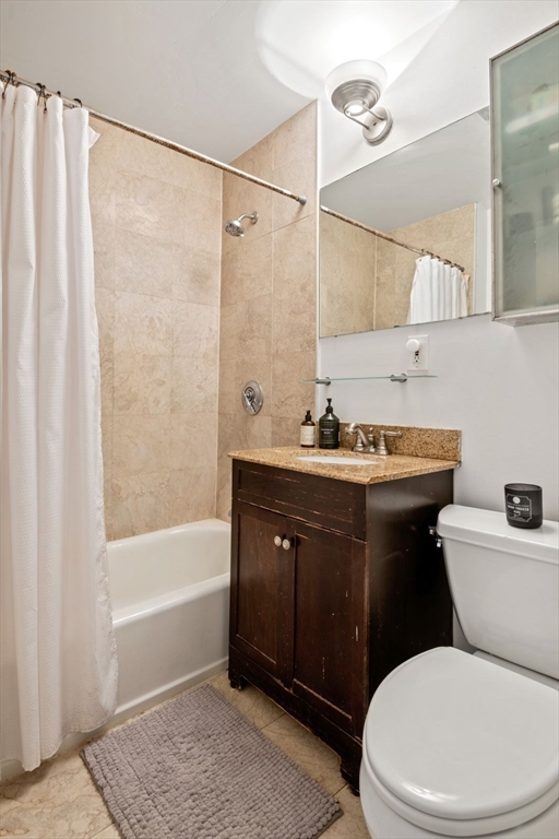 249 Roxbury Street, Unit 1 Boston, MA 02119 - Photo 12 of 19 a bathroom with a sink vanity mirror and toilet