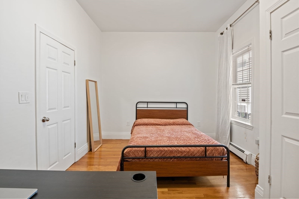 249 Roxbury Street, Unit 1 Boston, MA 02119 - Photo 15 of 19 a room with a bed and a window