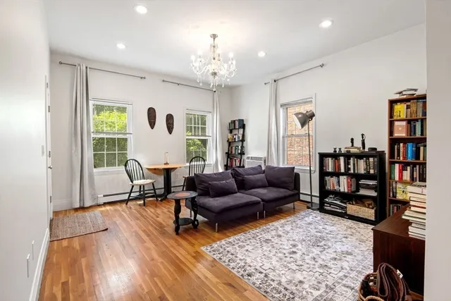 a living room with furniture a rug and a window