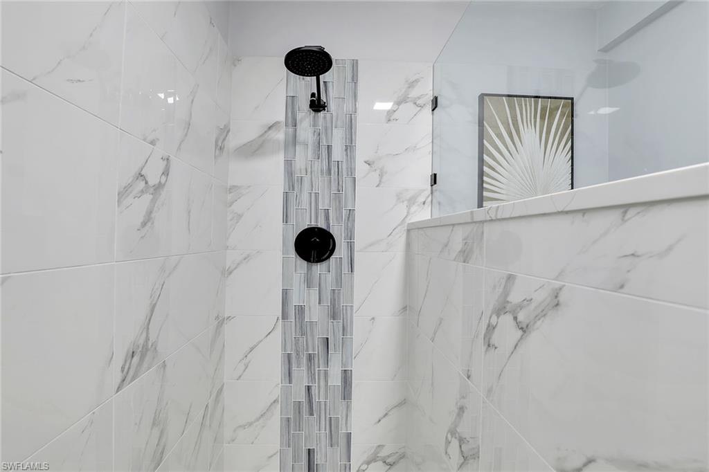 2780 Weeks Avenue Naples, FL 34112 - Photo 10 of 34 a bathroom with a shower
