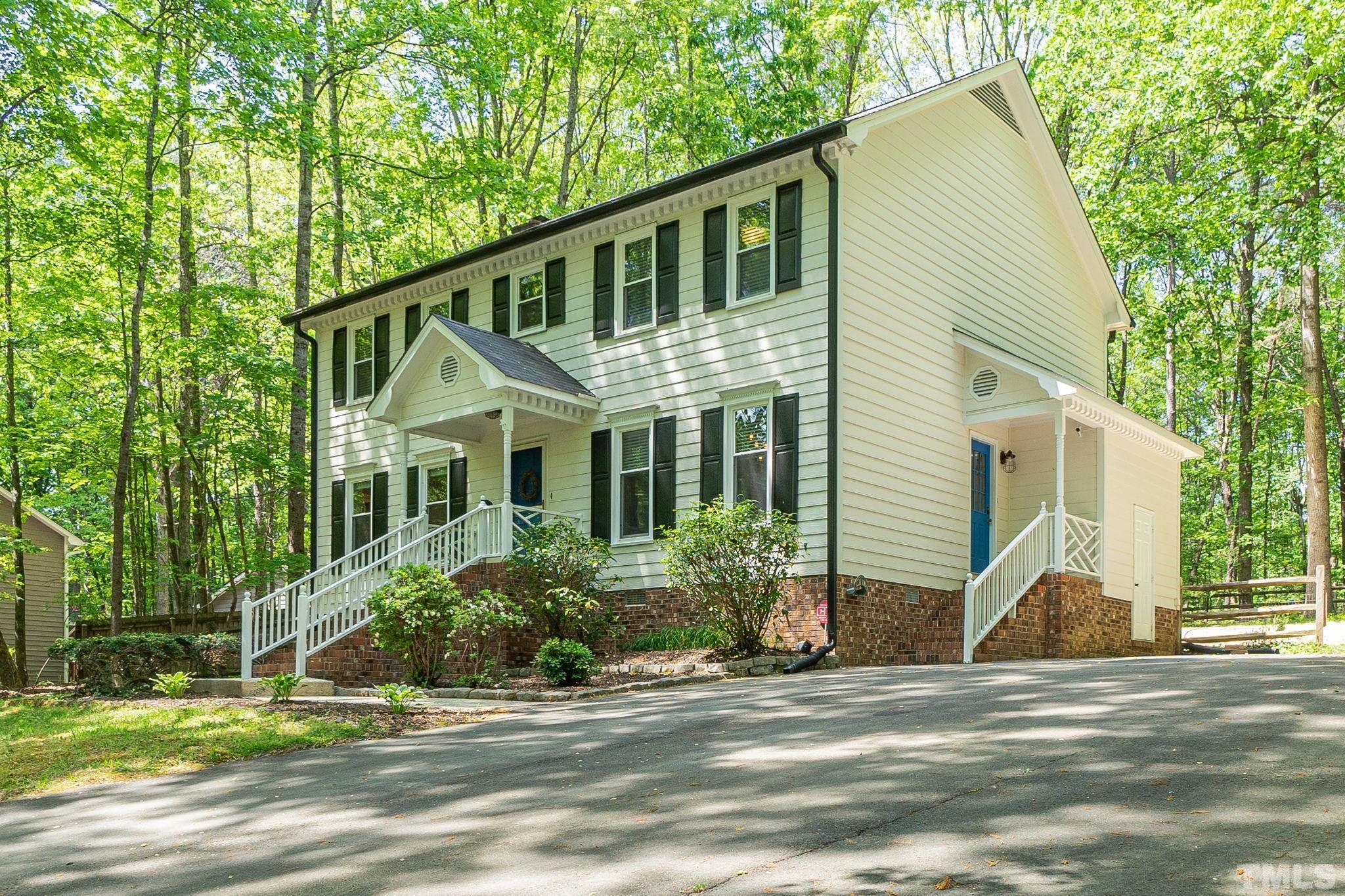 a view of a house with a yard and plants