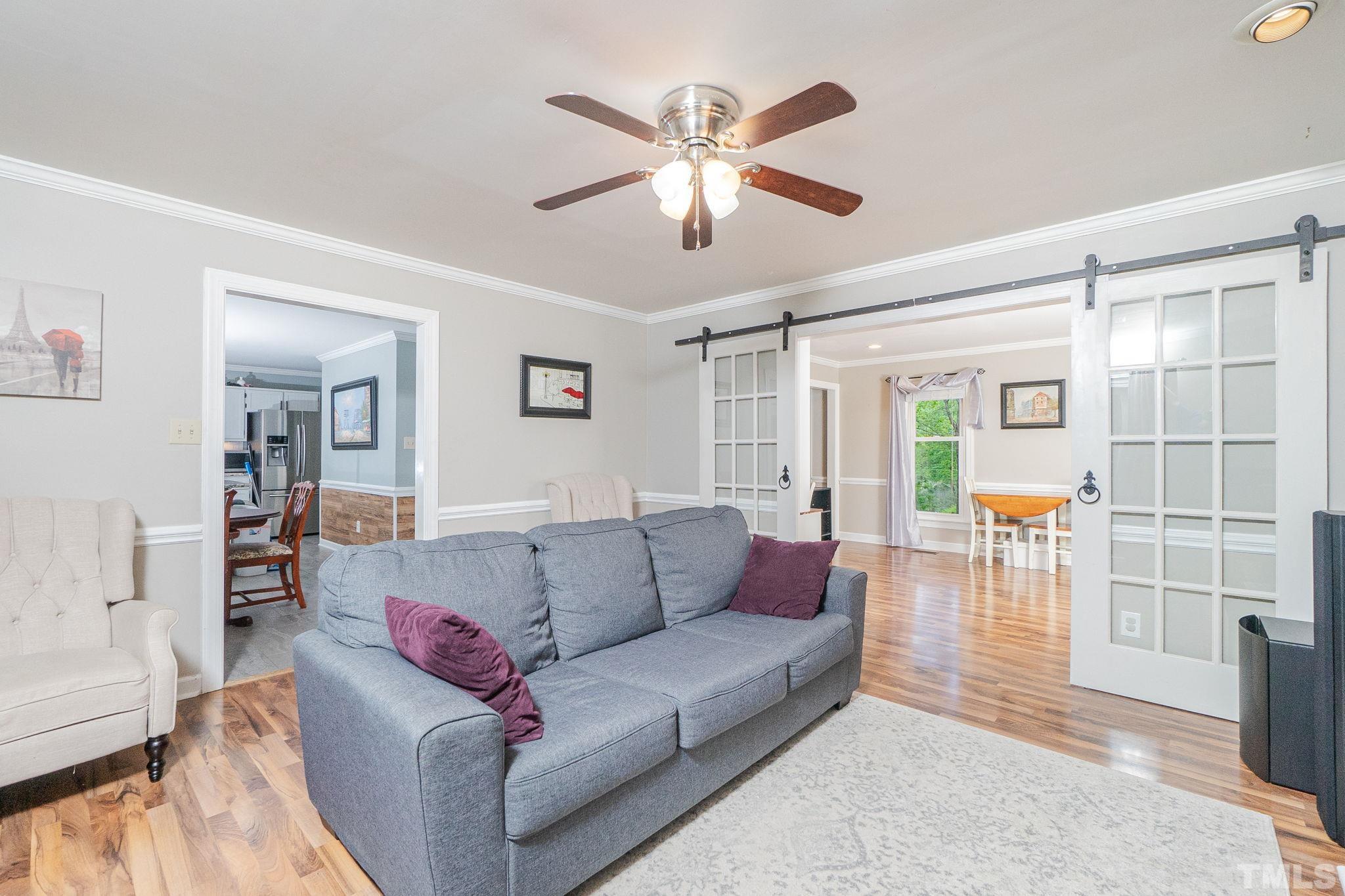 6313 Craig Road Durham, NC 27712 - Photo 14 of 38 a living room with furniture and a chandelier