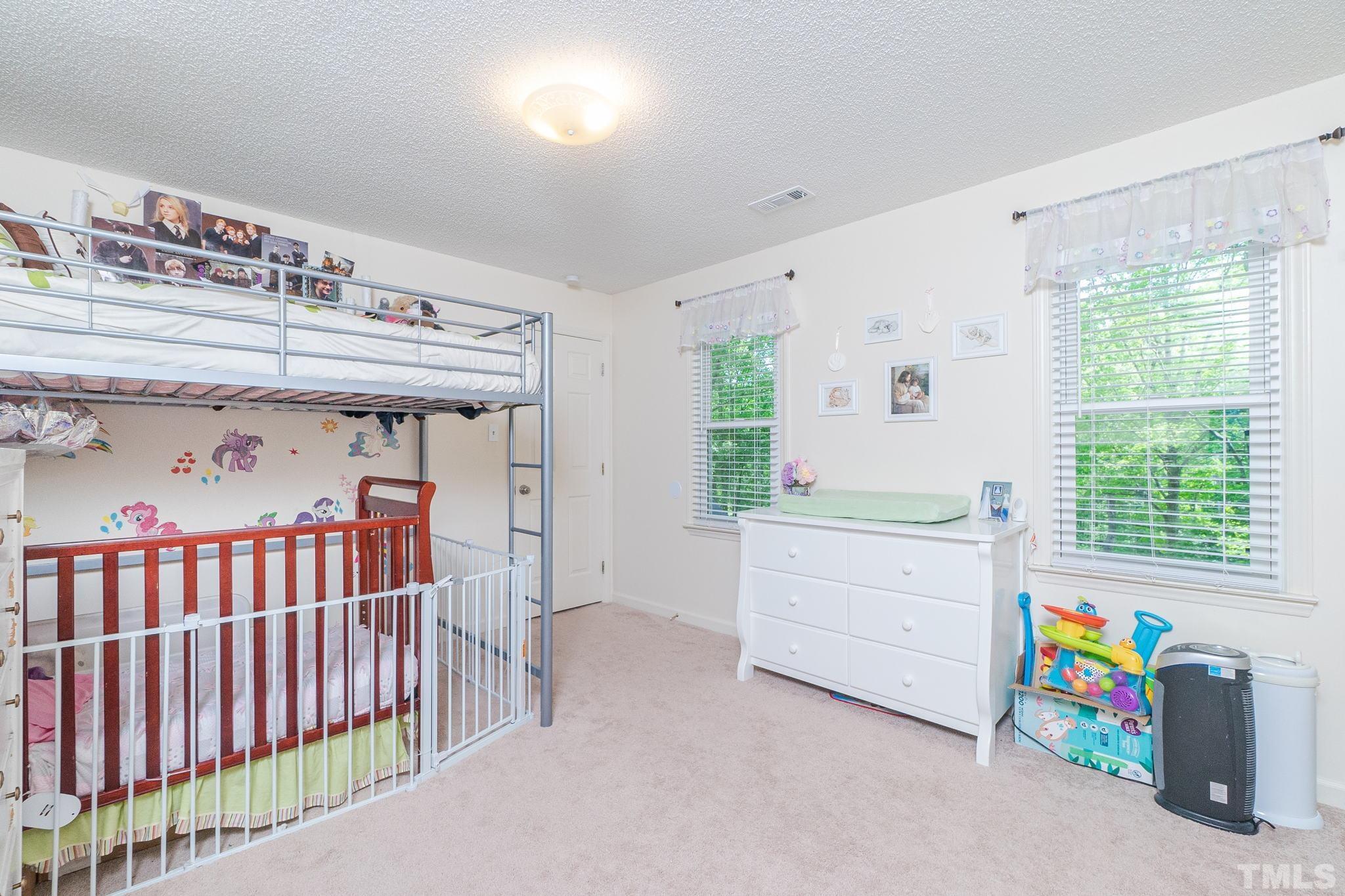 6313 Craig Road Durham, NC 27712 - Photo 31 of 38 a bedroom with a bed and a window
