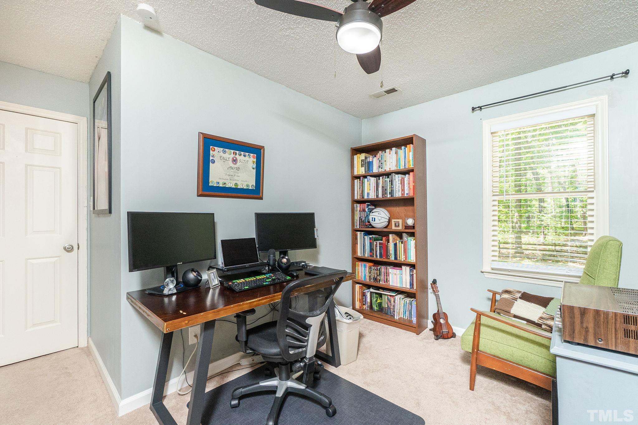 6313 Craig Road Durham, NC 27712 - Photo 33 of 38 a view of a workspace with furniture and a window