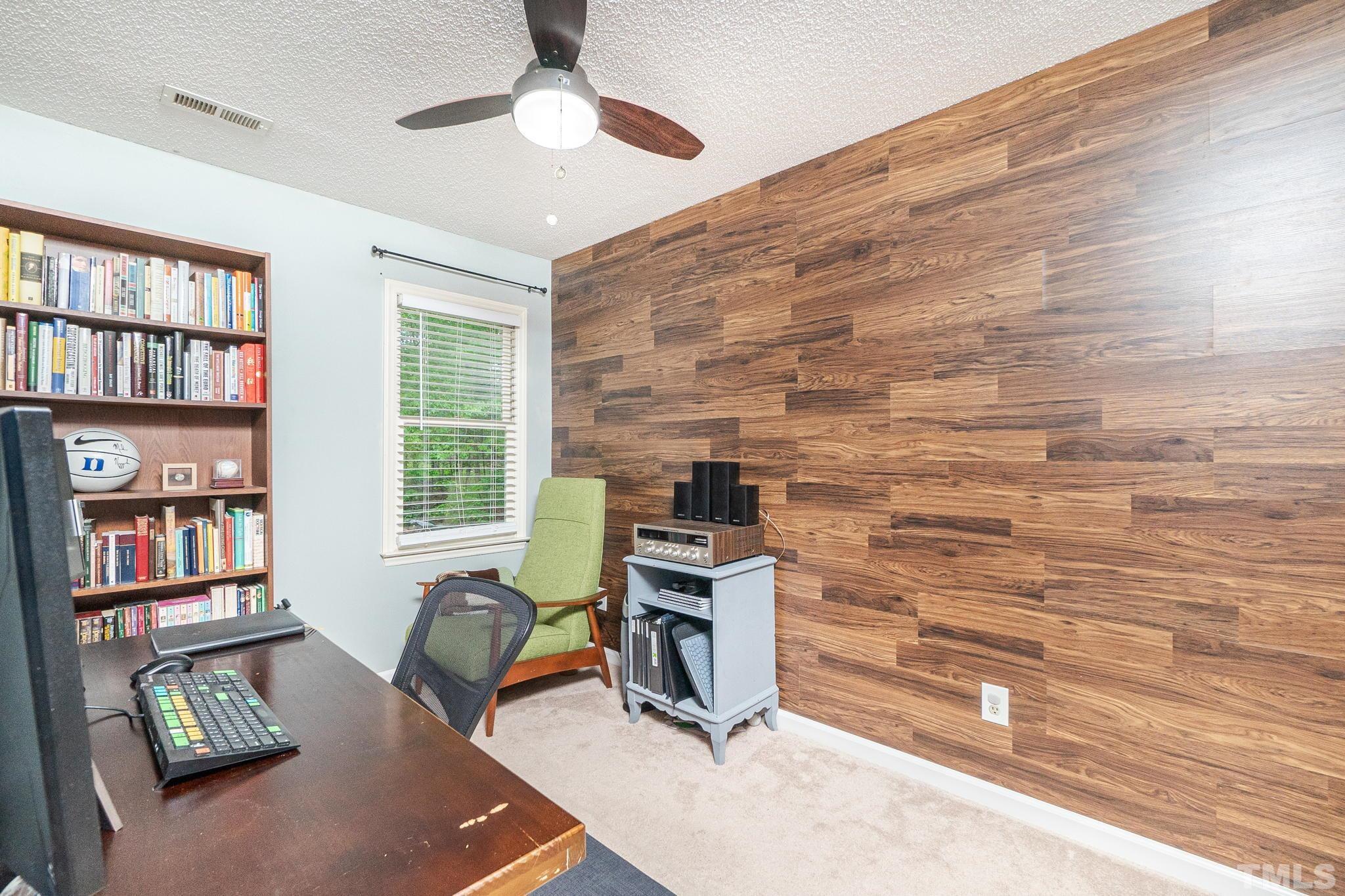 6313 Craig Road Durham, NC 27712 - Photo 34 of 38 a workspace with furniture and a book shelf