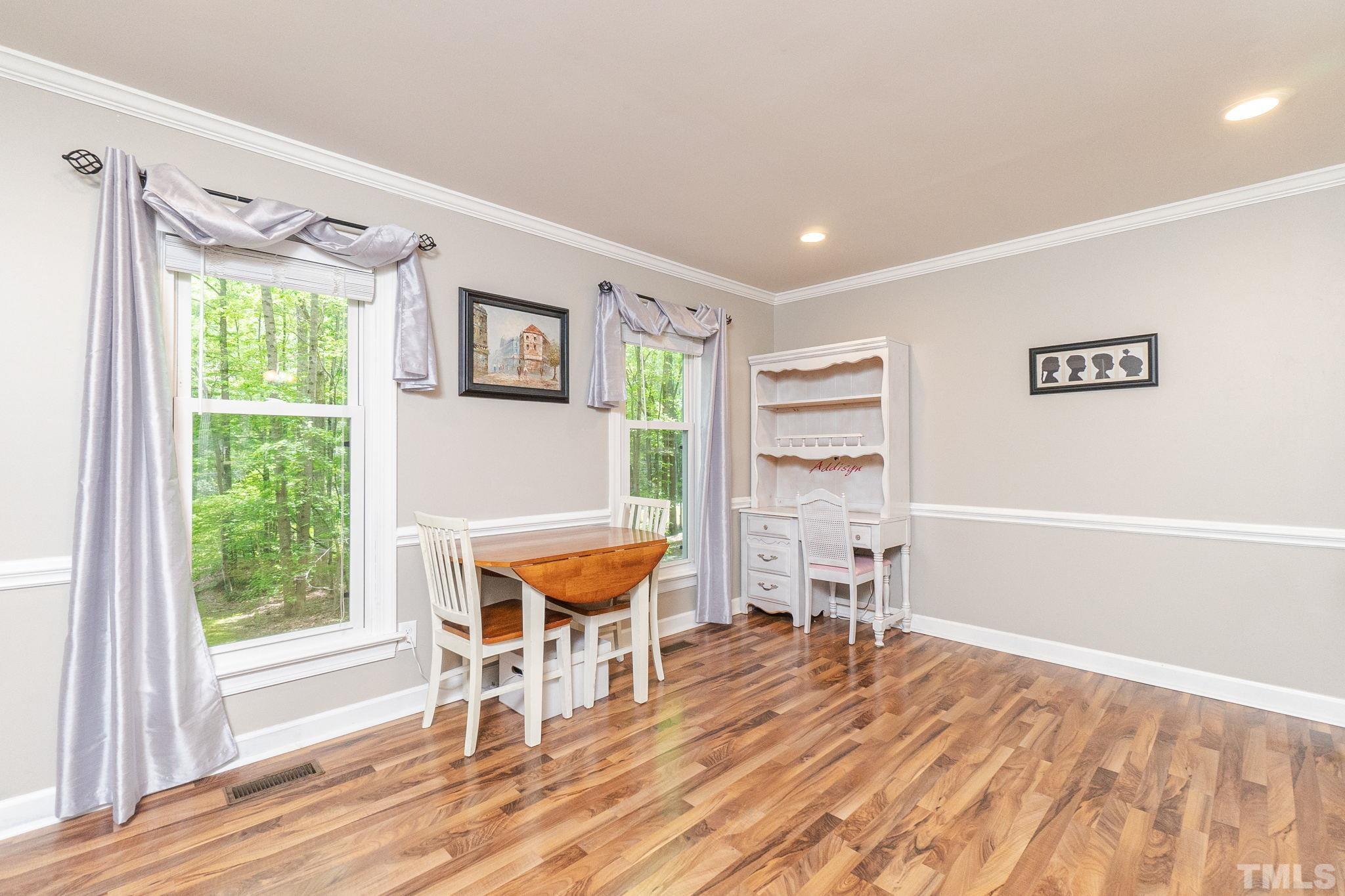 6313 Craig Road Durham, NC 27712 - Photo 8 of 38 a room with wooden floor and a window